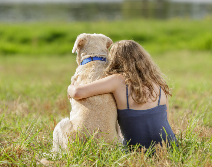 girl hugging dog